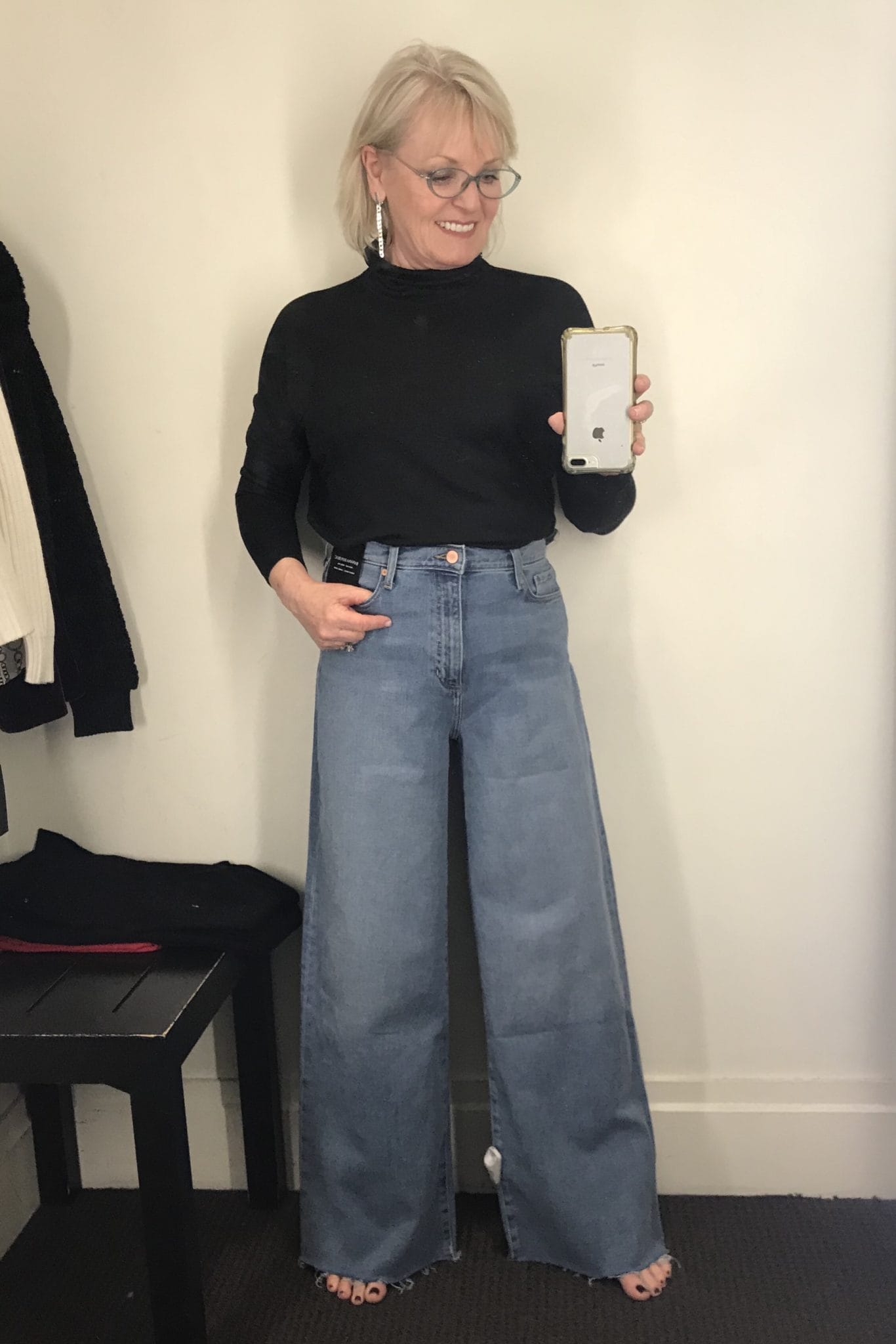 Jennifer Connolly of A Well Styled Life wearing high-rise wide=leg jeans with black turtleneck from Banana Republic